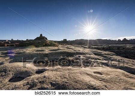 Stock Photography - "Sun in blue sky over desert, Moab, Utah, United States". Fotosearch