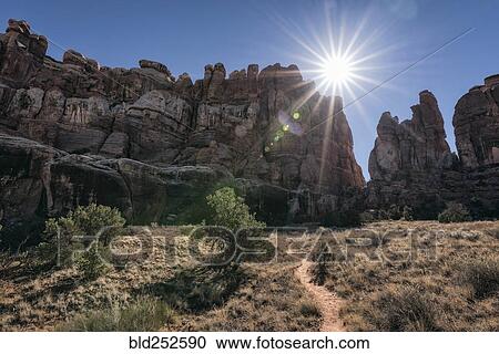 "Sun in blue sky over desert path, Moab, Utah, United States" View Large Photo Image Stock Image - "Sun in blue sky over desert path, Moab, Utah, United States". Fotosearch