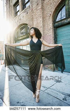 Sunbeams on mixed race woman dancing in city View Large Photo Image Stock Image - Sunbeams on mixed race woman dancing in city. Fotosearch