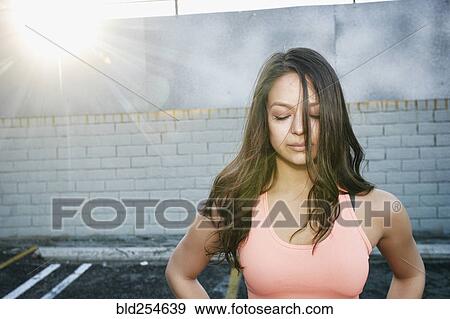 Sunbeams on mixed race woman in parking lot View Large Photo Image Stock Photo - Sunbeams on mixed race woman in parking lot. Fotosearch