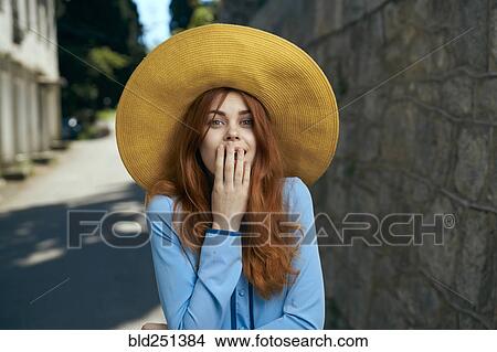 Surprised Caucasian woman wearing hat near stone wall View Large Photo Image Picture - Surprised Caucasian woman wearing hat near stone wall. Fotosearch