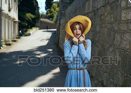 Surprised Caucasian woman wearing hat near stone wall View Large Photo Image Stock Image - Surprised Caucasian woman wearing hat near stone wall. Fotosearch