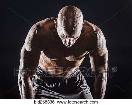 Sweating Black man bending and resting View Large Photo Image Stock Photograph - Sweating Black man bending and resting. Fotosearch