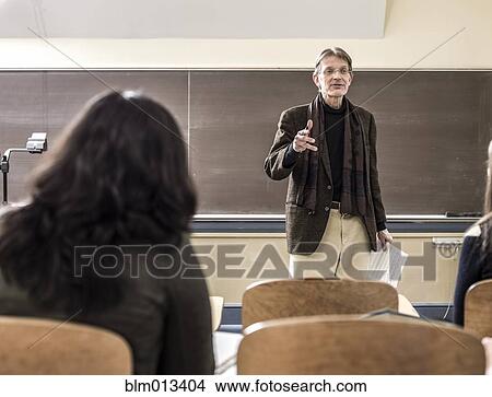 Picture - Teacher talking to students in classroom. Fotosearch