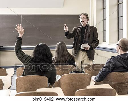 Teacher talking to students in classroom View Large Photo Image Stock Image - Teacher talking to students in classroom. Fotosearch