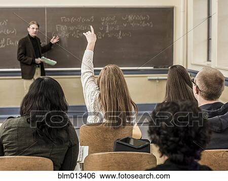Stock Photograph - Teacher talking to students in classroom. Fotosearch