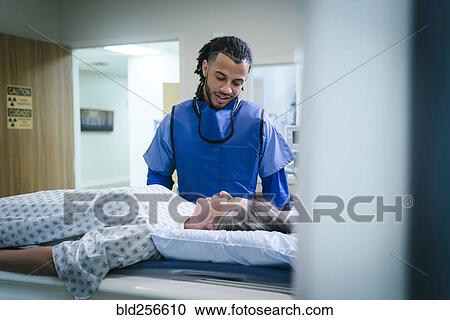 Technician talking to patient near scanner View Large Photo Image Stock Image - Technician talking to patient near scanner. Fotosearch