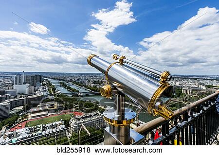 Stock Photo - "Telescope at scenic view of river in city, Paris, Ile de France, France". Fotosearch