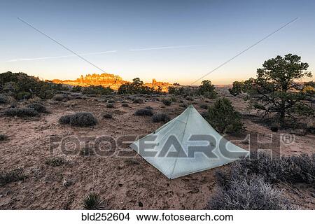 Picture - "Tent in desert at sunset, Moab, Utah, United States". Fotosearch