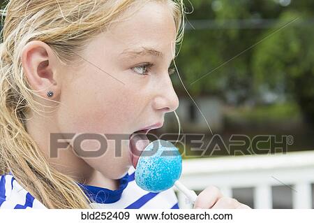 Tongue of Caucasian girl licking blue lollipop View Large Photo Image Stock Photo - Tongue of Caucasian girl licking blue lollipop. Fotosearch