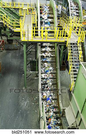 Stock Image - Trash on conveyor belt at factory. Fotosearch