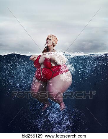 Underwater review of overweight woman swimming View Large Photo Image Stock Photo - Underwater review of overweight woman swimming. Fotosearch
