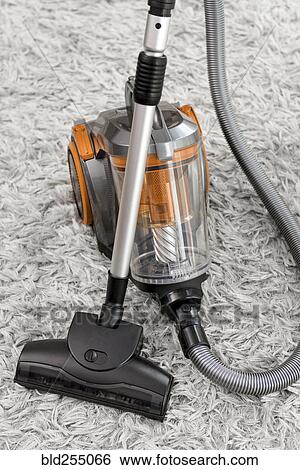 Stock Photograph - Vacuum on white shag carpet. Fotosearch