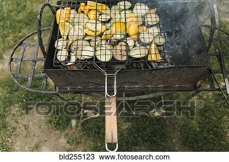 Vegetables cooking on grill View Large Photo Image Stock Image - Vegetables cooking on grill. Fotosearch