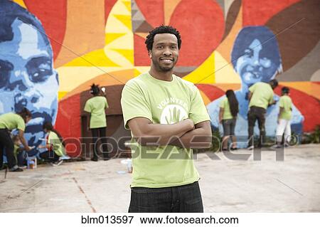 Stock Photo - Volunteers painting wall. Fotosearch