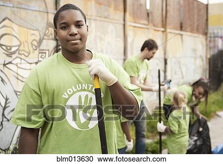 Stock Image - Volunteers picking up litter. Fotosearch