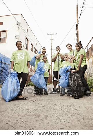 Stock Image - Volunteers picking up litter. Fotosearch