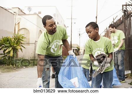 Volunteers picking up litter View Large Photo Image Stock Photo - Volunteers picking up litter. Fotosearch