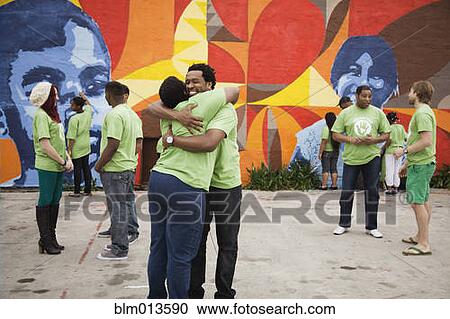Stock Image - Volunteers standing together. Fotosearch