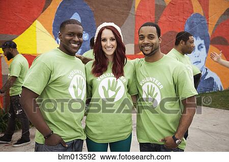 Stock Image - Volunteers standing together. Fotosearch