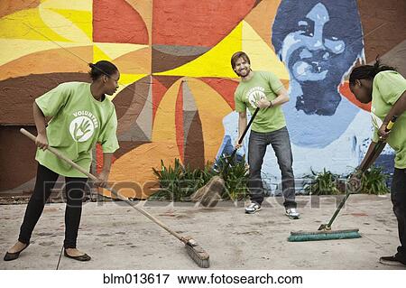 Stock Photo - Volunteers sweeping ground. Fotosearch