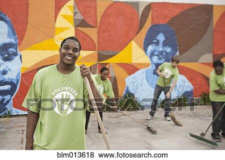 Stock Photo - Volunteers sweeping ground. Fotosearch