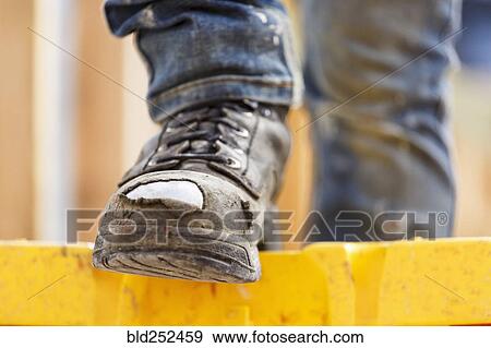 Warn boot of Caucasian woman at construction site View Large Photo Image Stock Photo - Warn boot of Caucasian woman at construction site. Fotosearch