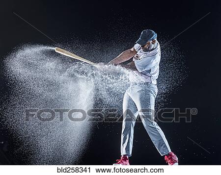 Stock Image - Water splashing on Black baseball player swinging bat. Fotosearch