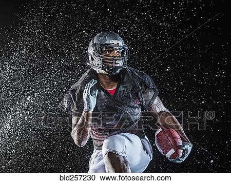 Water splashing on black football player running View Large Photo Image Stock Image - Water splashing on black football player running. Fotosearch