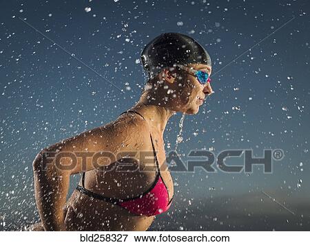 Stock Photo - Water splashing on Caucasian swimmer. Fotosearch