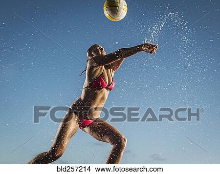 Water splashing on Caucasian woman playing volleyball View Large Photo Image Picture - Water splashing on Caucasian woman playing volleyball. Fotosearch