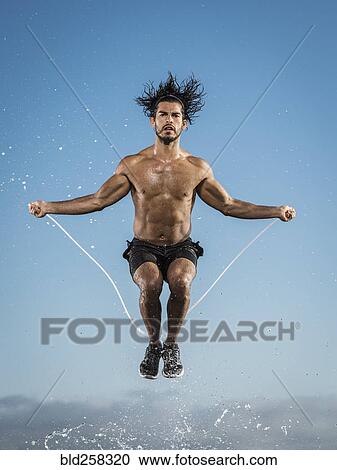 Water splashing on Hispanic man jumping rope View Large Photo Image Stock Image - Water splashing on Hispanic man jumping rope. Fotosearch