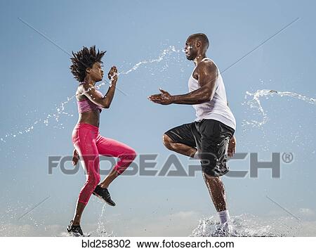 Water splashing on running Black couple View Large Photo Image Stock Image - Water splashing on running Black couple. Fotosearch