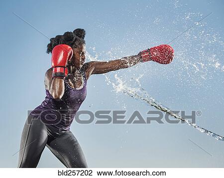 Water spraying on black woman boxing View Large Photo Image Stock Image - Water spraying on black woman boxing. Fotosearch