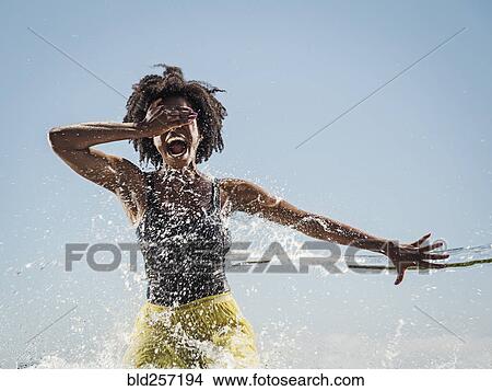 Water spraying on black woman dancing View Large Photo Image Picture - Water spraying on black woman dancing. Fotosearch