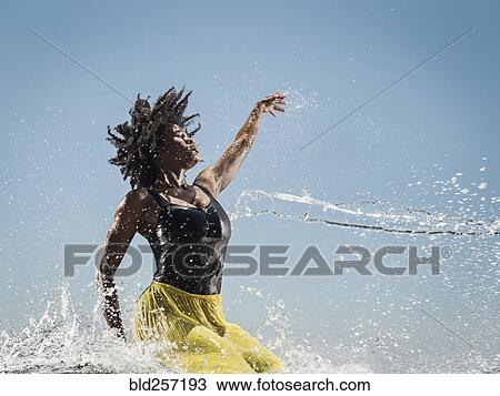 Water spraying on black woman dancing View Large Photo Image Stock Image - Water spraying on black woman dancing. Fotosearch
