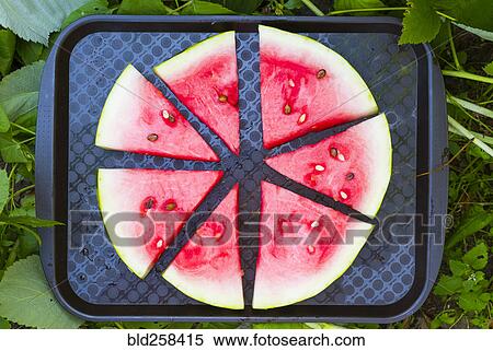 Stock Photography - Watermelon slices on plastic tray. Fotosearch