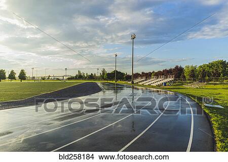 Wet bleachers and running track View Large Photo Image Picture - Wet bleachers and running track. Fotosearch