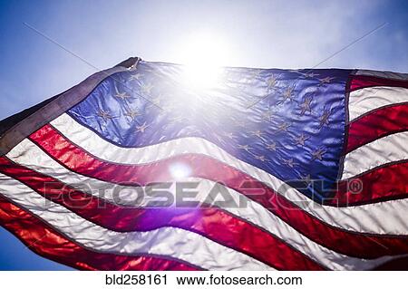 Wind blowing American flag on sunny day View Large Photo Image Stock Image - Wind blowing American flag on sunny day. Fotosearch