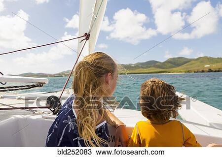 Wind blowing hair of Caucasian brother and sister in sailboat View Large Photo Image Stock Image - Wind blowing hair of Caucasian brother and sister in sailboat. Fotosearch