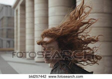 Wind blowing hair of Caucasian woman near pillars View Large Photo Image Stock Image - Wind blowing hair of Caucasian woman near pillars. Fotosearch
