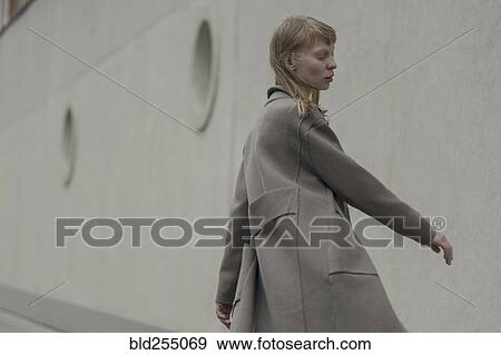 Wind blowing hair of Caucasian woman wearing coat View Large Photo Image Stock Photo - Wind blowing hair of Caucasian woman wearing coat. Fotosearch