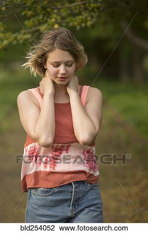 Stock Image - Wind blowing hair of pensive Caucasian teenage girl. Fotosearch