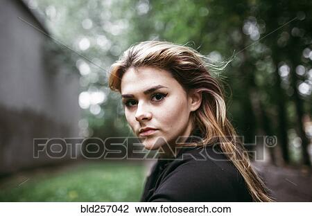 Stock Image - Wind blowing hair of serious Caucasian woman. Fotosearch