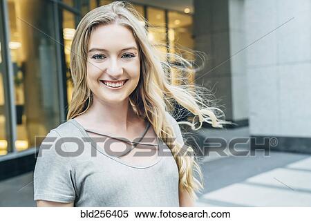 Wind blowing hair of smiling Caucasian woman View Large Photo Image Stock Photography - Wind blowing hair of smiling Caucasian woman. Fotosearch
