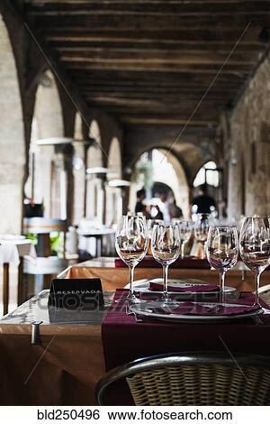 Wine glasses on reserved table View Large Photo Image Stock Photograph - Wine glasses on reserved table. Fotosearch