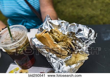 Woman holding hot dog and soda with ice View Large Photo Image Stock Image - Woman holding hot dog and soda with ice. Fotosearch