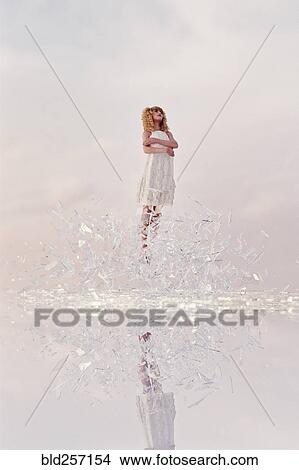 Picture - Woman hovering in shards of glass. Fotosearch