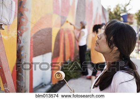 Picture - Woman painting wall. Fotosearch