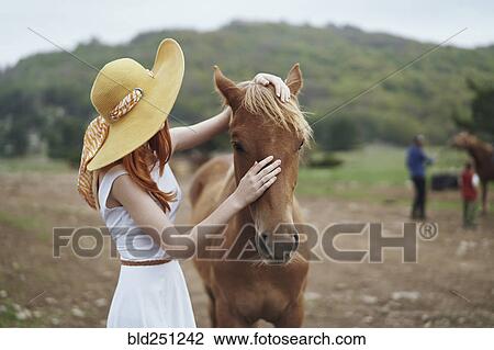 Woman petting horse View Large Photo Image Stock Image - Woman petting horse. Fotosearch